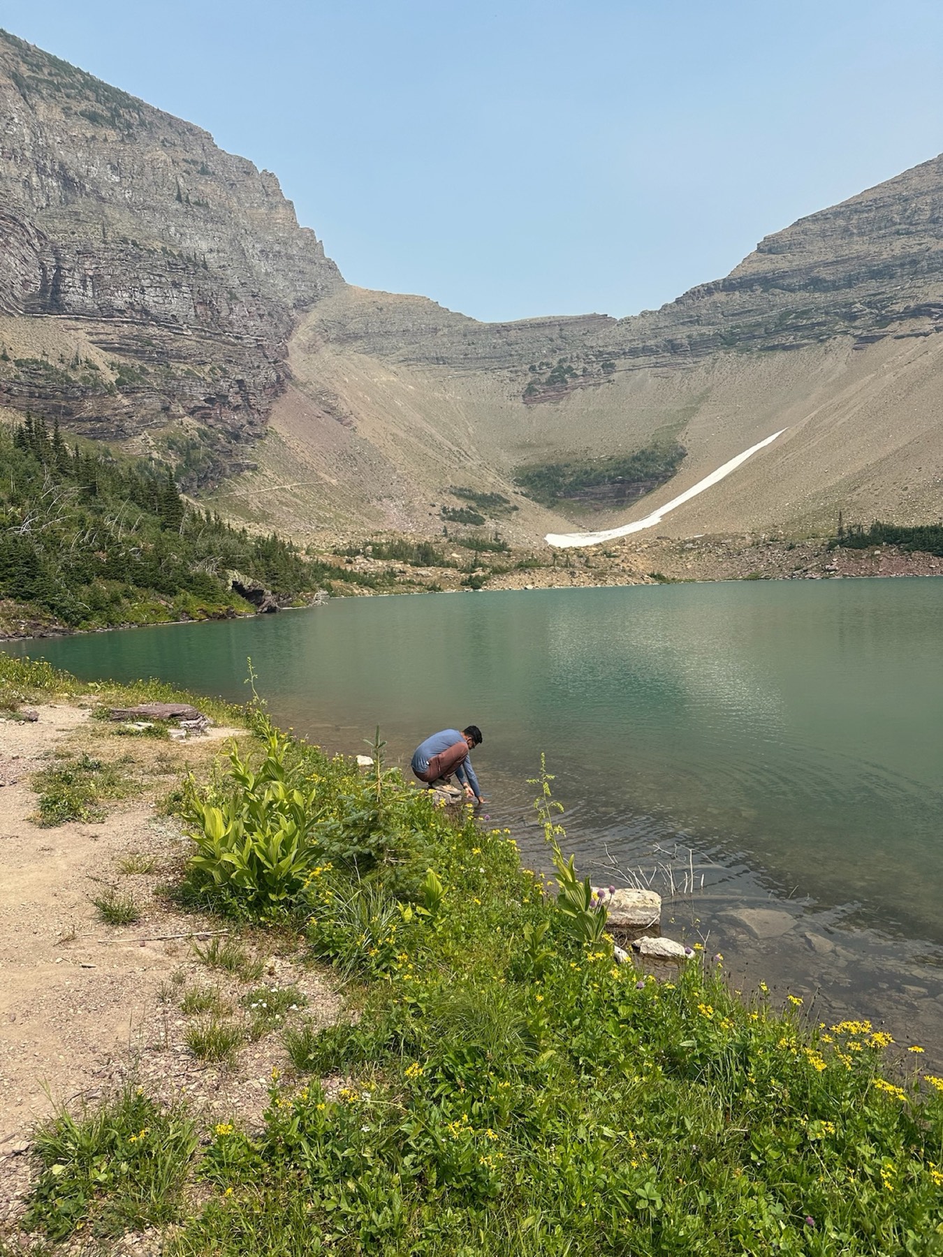 Filling water at a lake along the trail