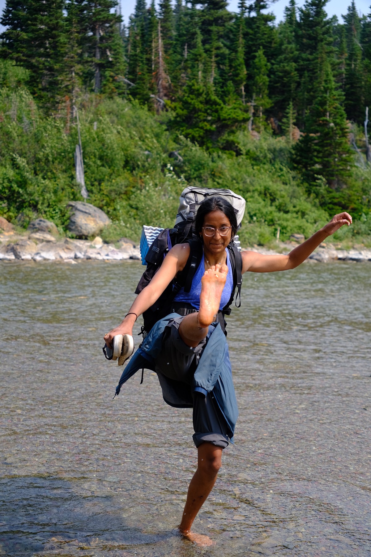 MN crossing the Mokowanis River barefoot, sandals in hand