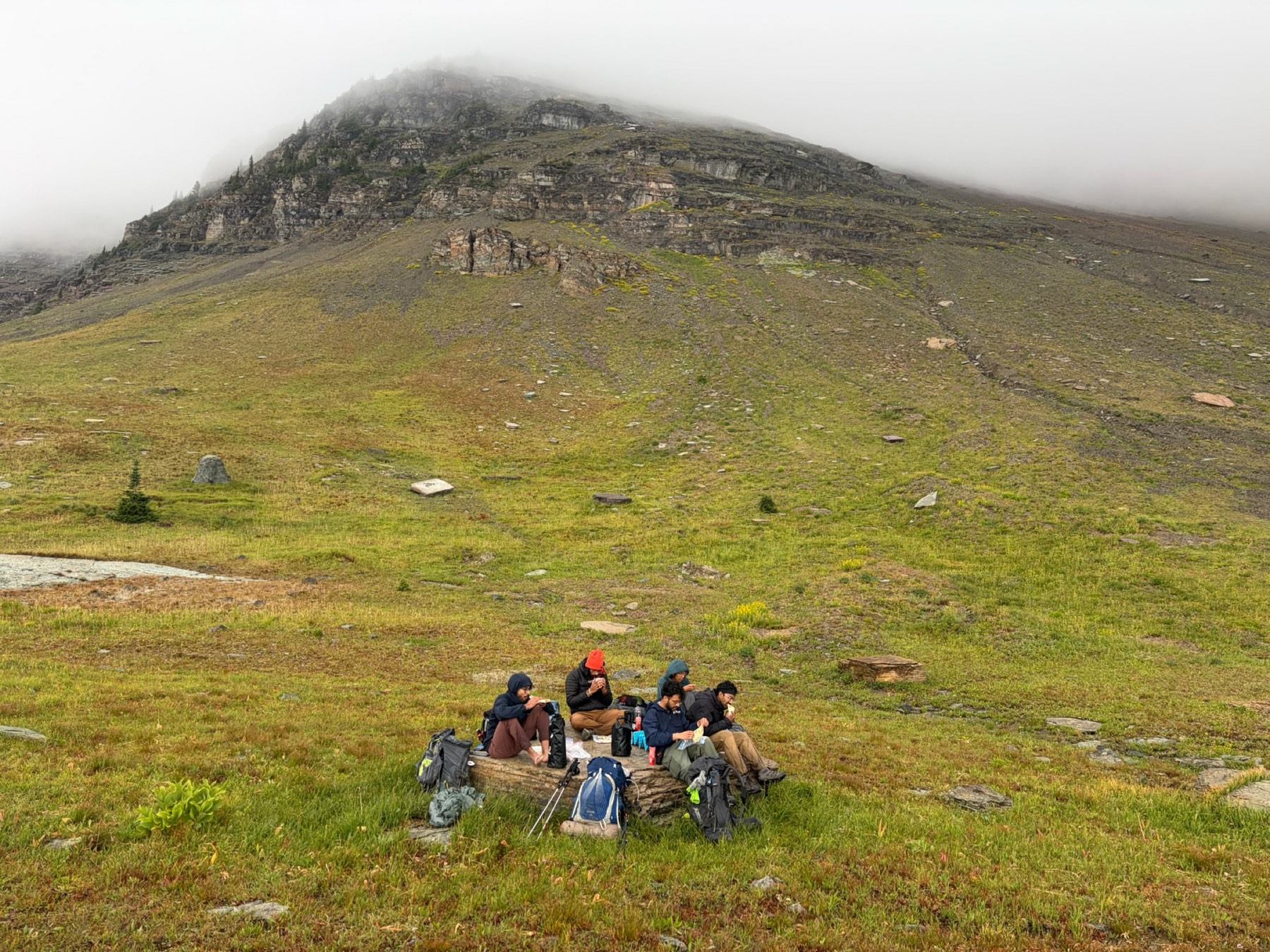 The group having lunch on a conveniently placed rock